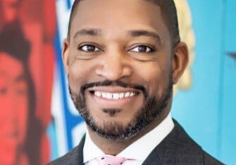 Smiling man in a suit and tie.