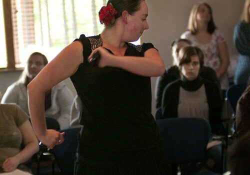 Woman in black dress dancing