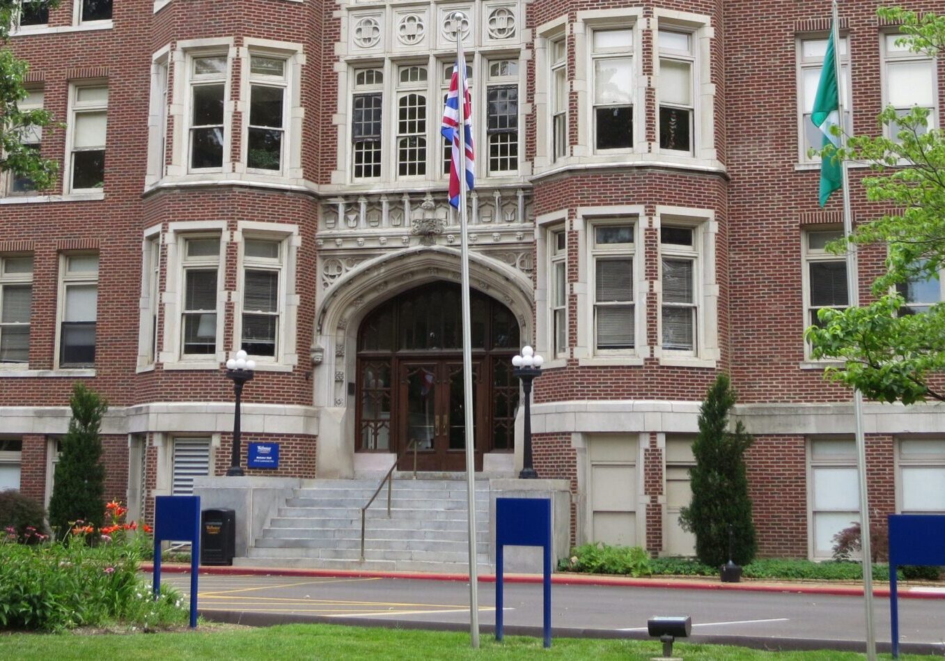 Red brick building with flags displayed