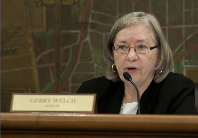 Woman with glasses at microphone