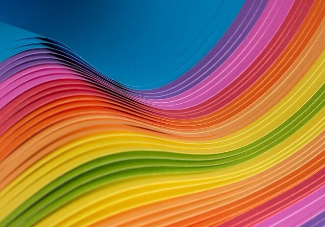 Rainbow-hued paper layers forming curves