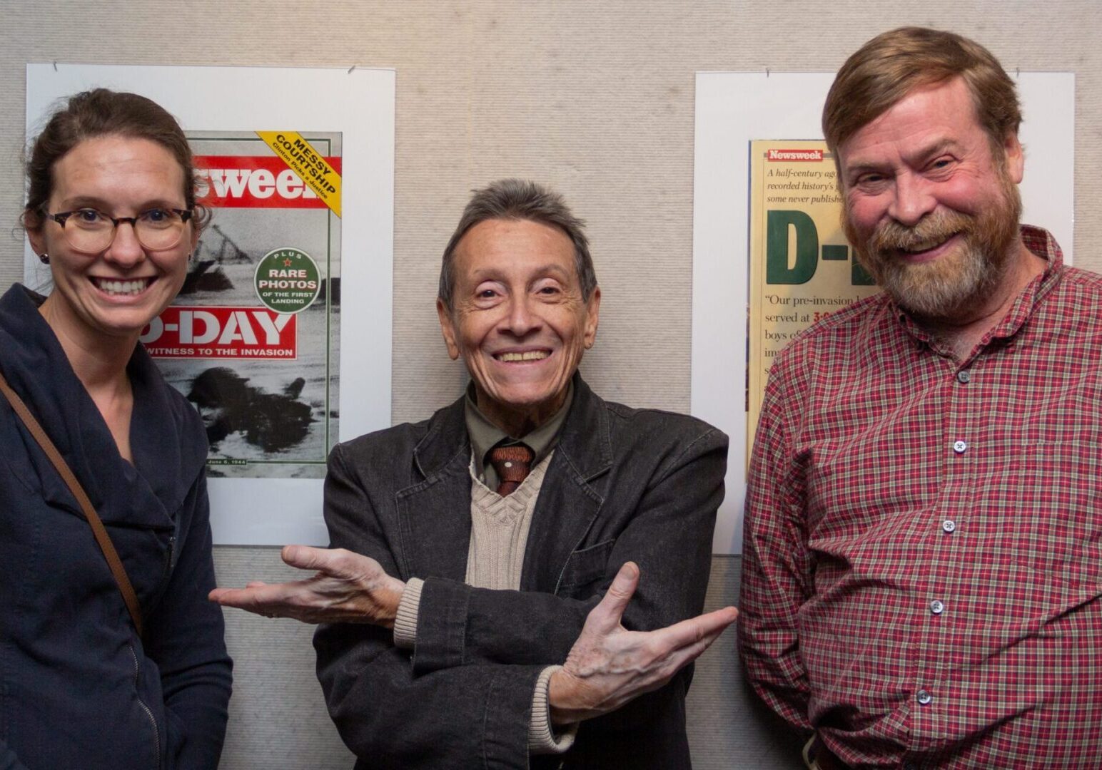 Group posing with historical magazine covers