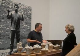 People examining sculptures in museum