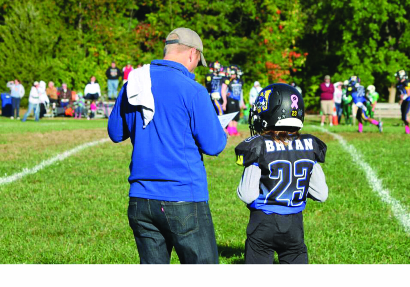 Football player number 23 with coach