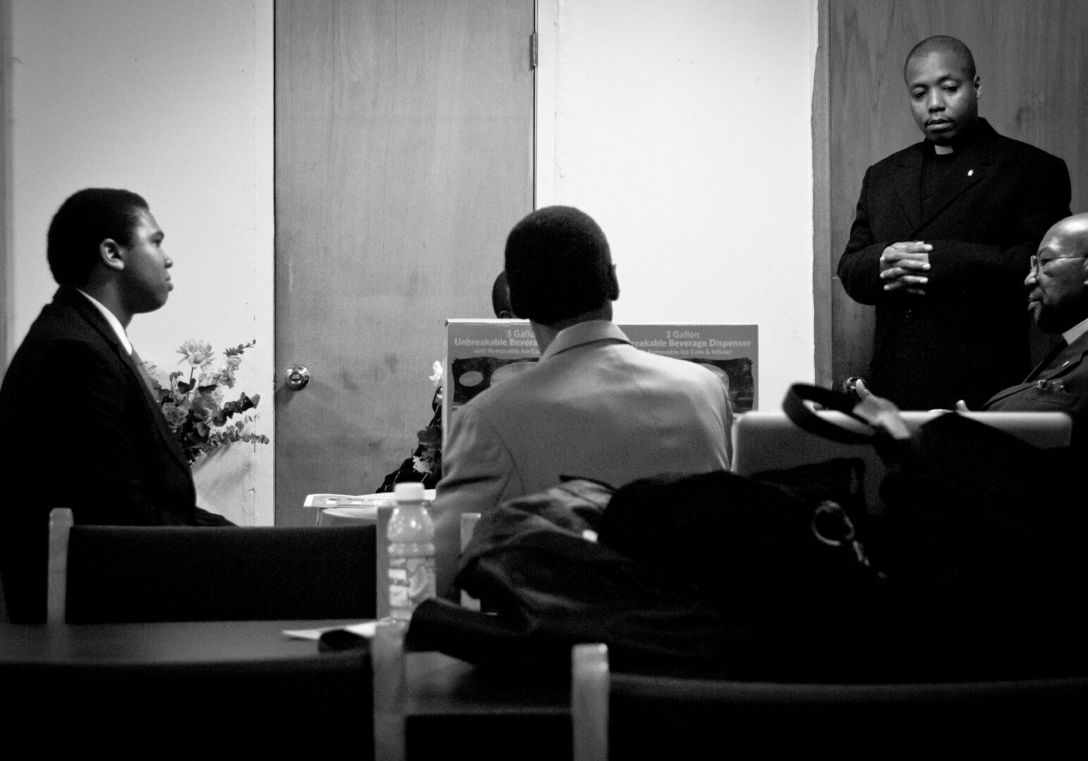 Clergyman standing during a meeting