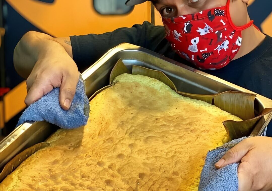 Man holding large baked cake