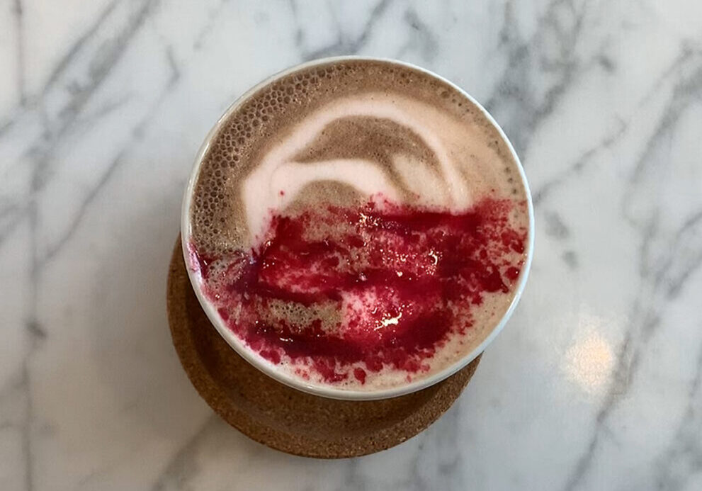Creamy latte with vibrant red design