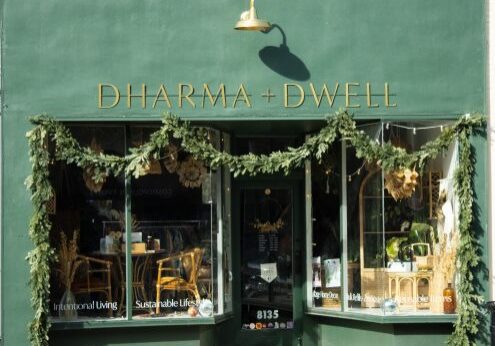 Green storefront with festive garland