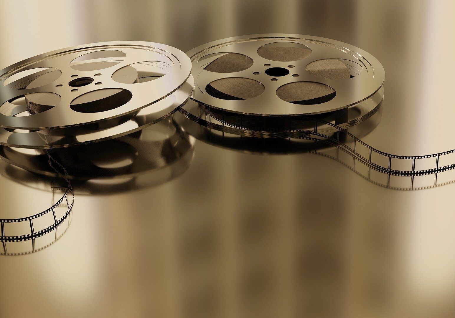 Two metal movie reels with filmstrip
