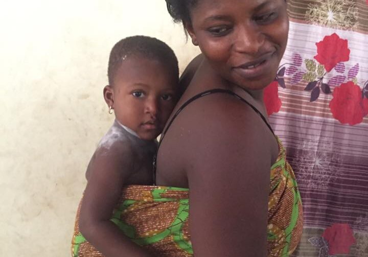 Parent with infant in colorful fabric wrap