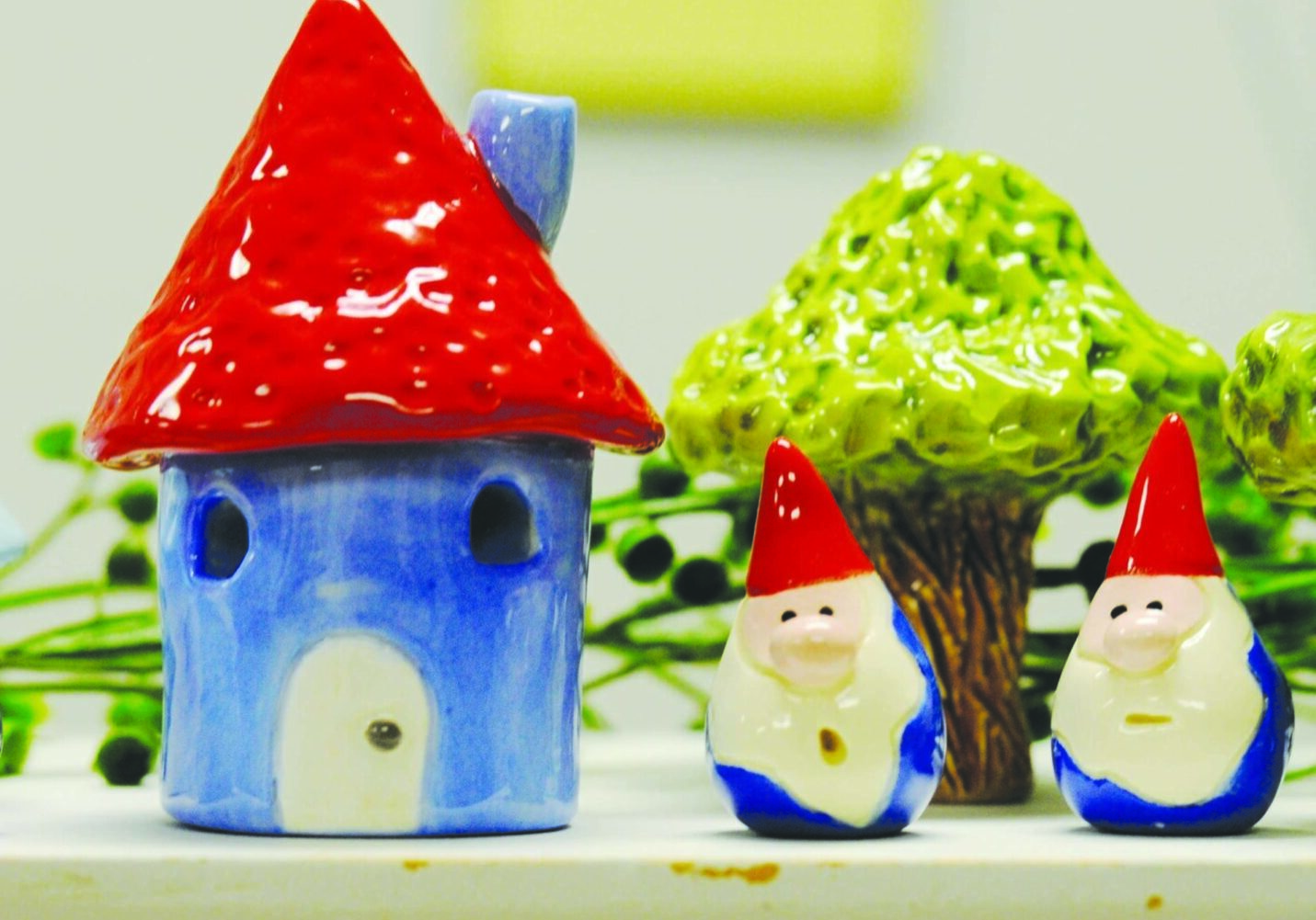 Ceramic house with gnomes and tree figurines