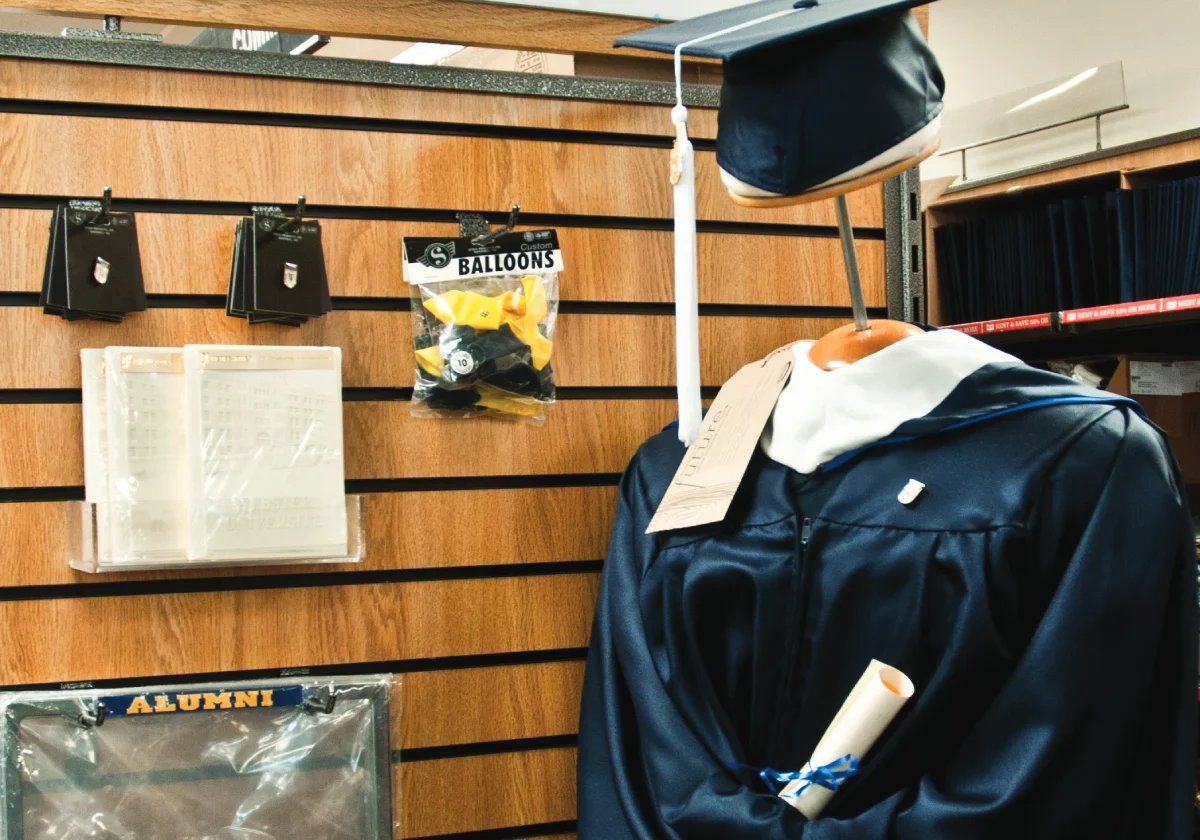 Graduation gown and cap on display