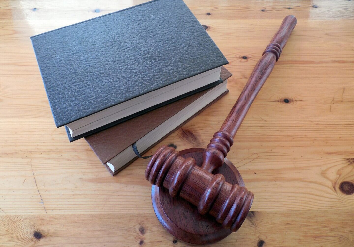 Gavel and books on wooden table