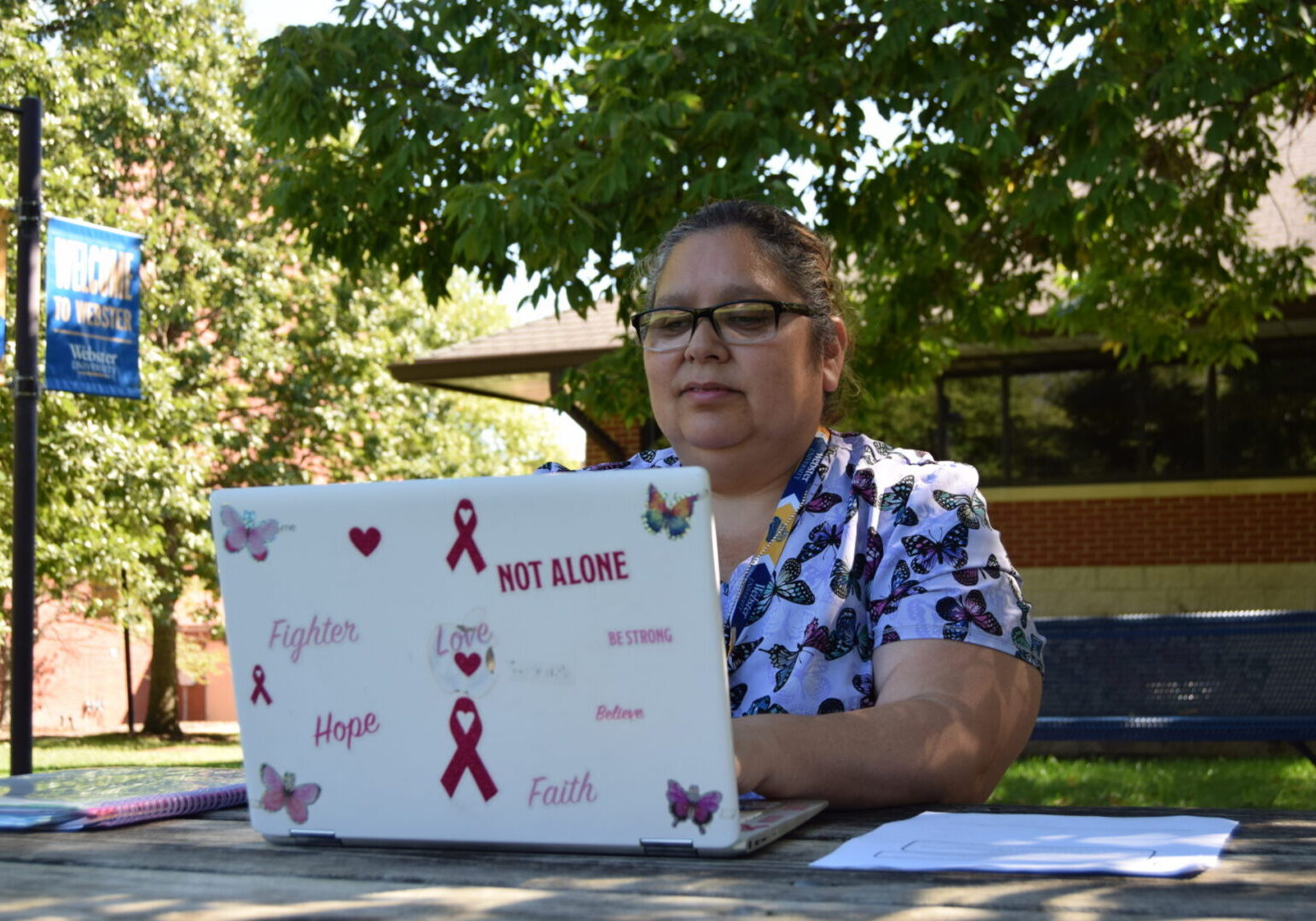 Norma Zamora works on her homework while sitting in The Quad. Photo by Styx Nappier