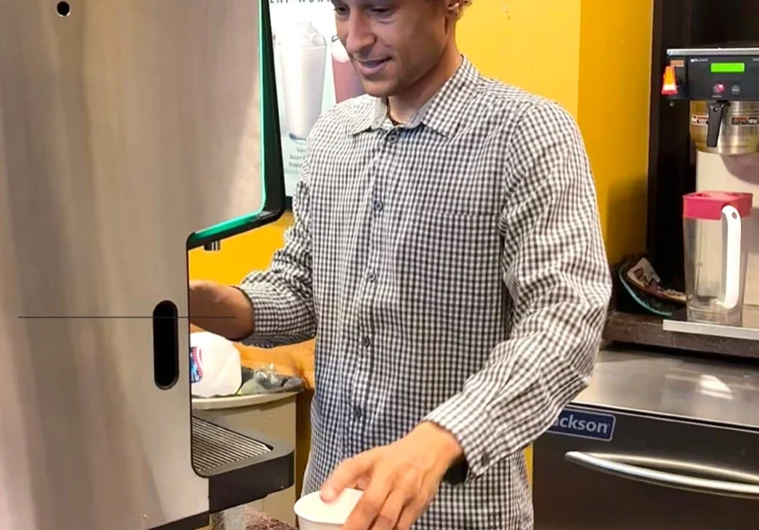 Smiling barista behind the counter