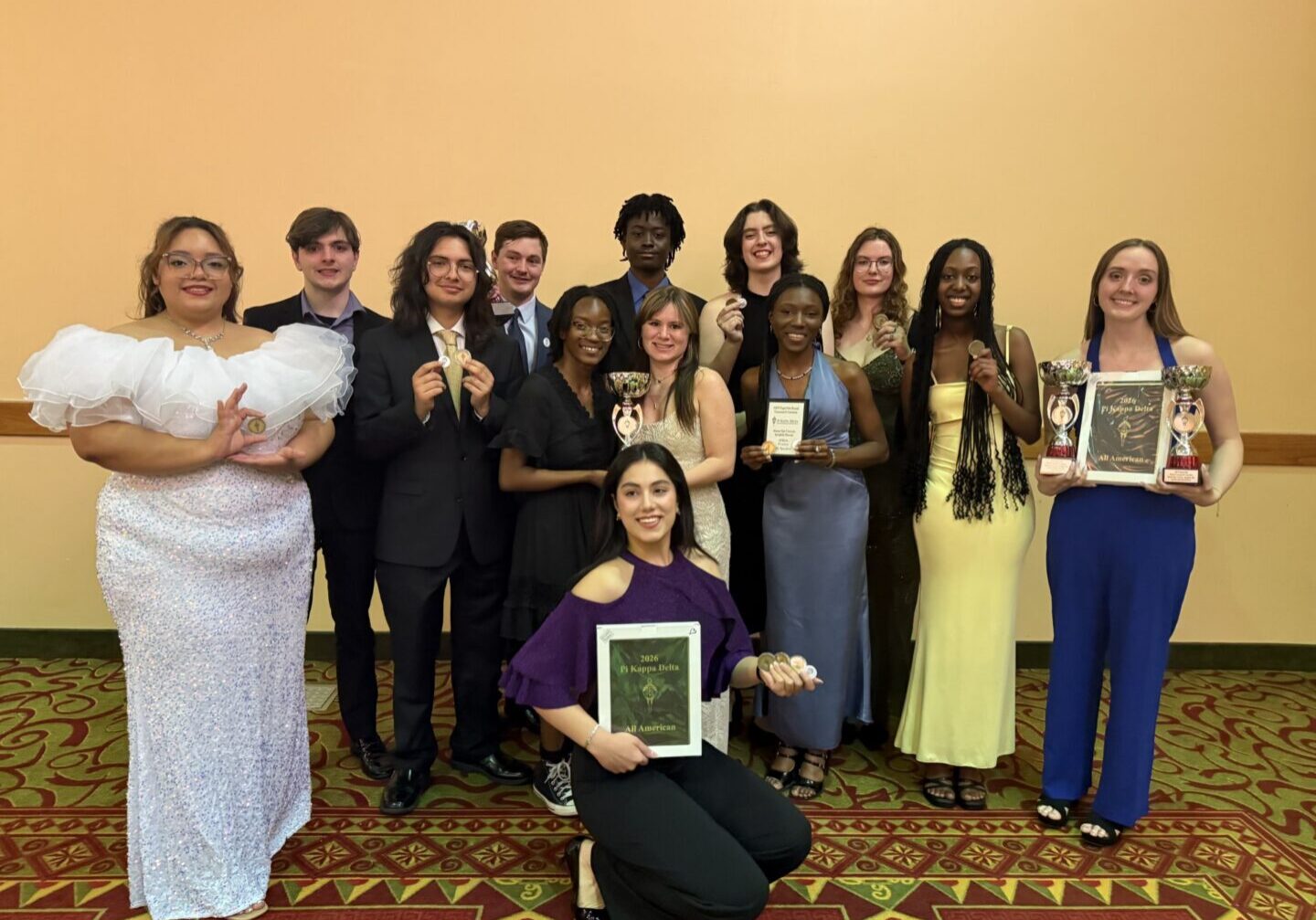 The Speech and Debate Club showcase their awards at the Phi Kappa Delta National Tournament banquet. Photo contributed by Gina Jensen