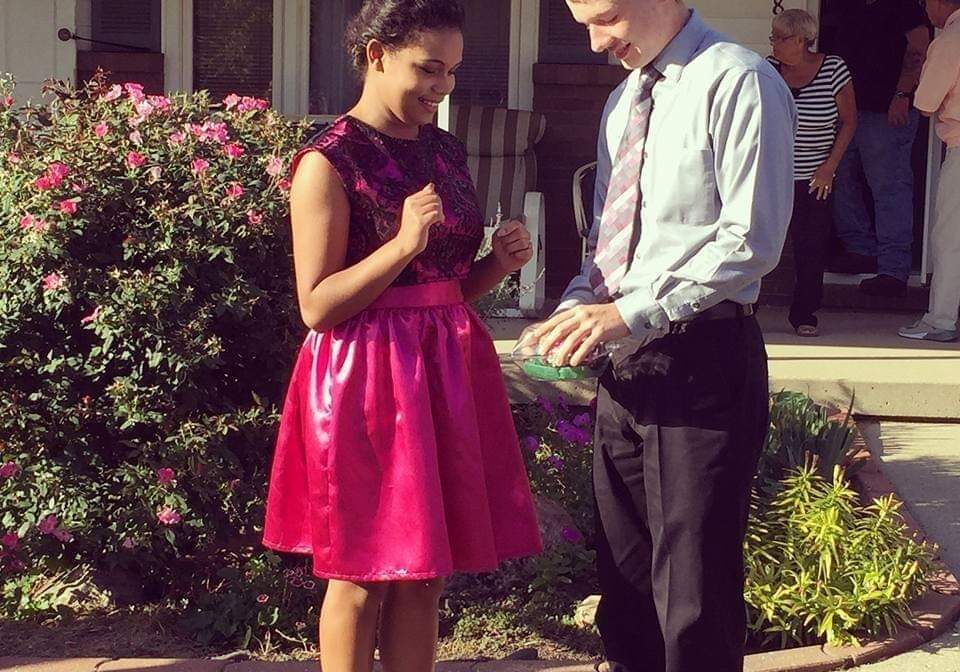 Girl in pink dress with boy in tie
