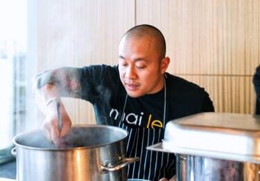 Person preparing food in professional setting.