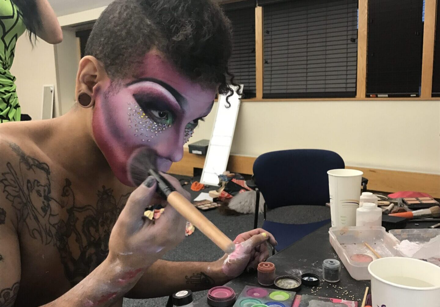 Drag artist doing makeup preparation
