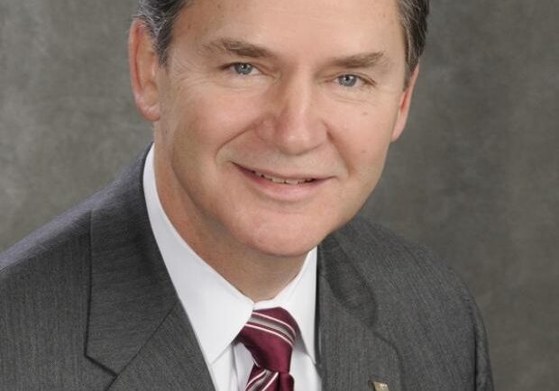 Businessman smiling in gray suit