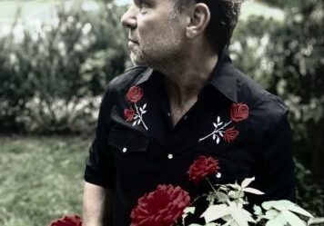 Man holding roses in a garden