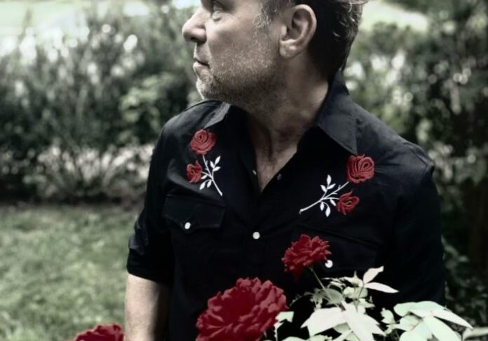 Individual standing among blooming roses