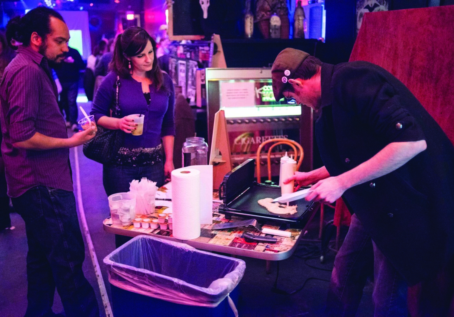 Indoor gathering with art demonstration.