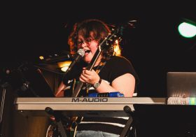 Musician performing with keyboard on stage