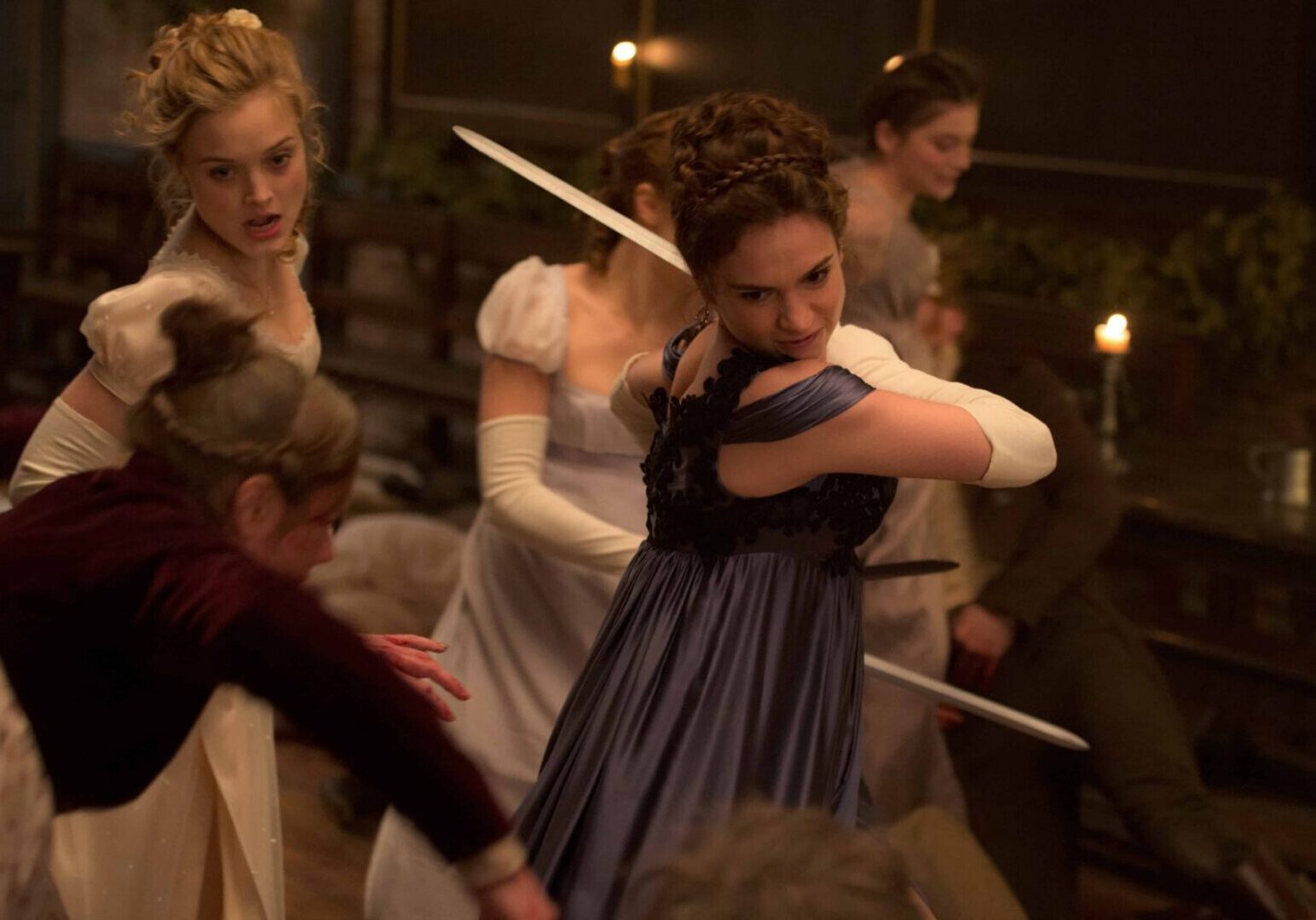 Women fighting with swords in period costumes.