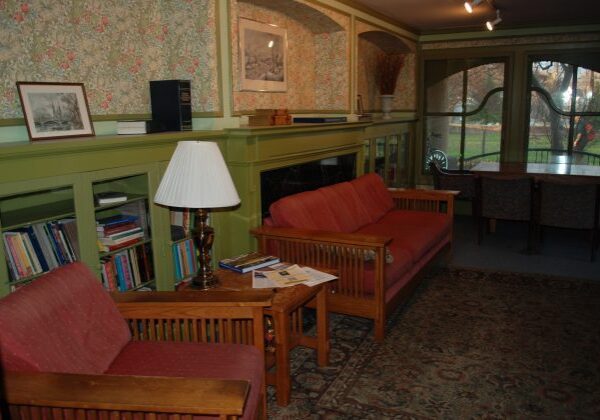 Vintage room with floral wallpaper and sofas