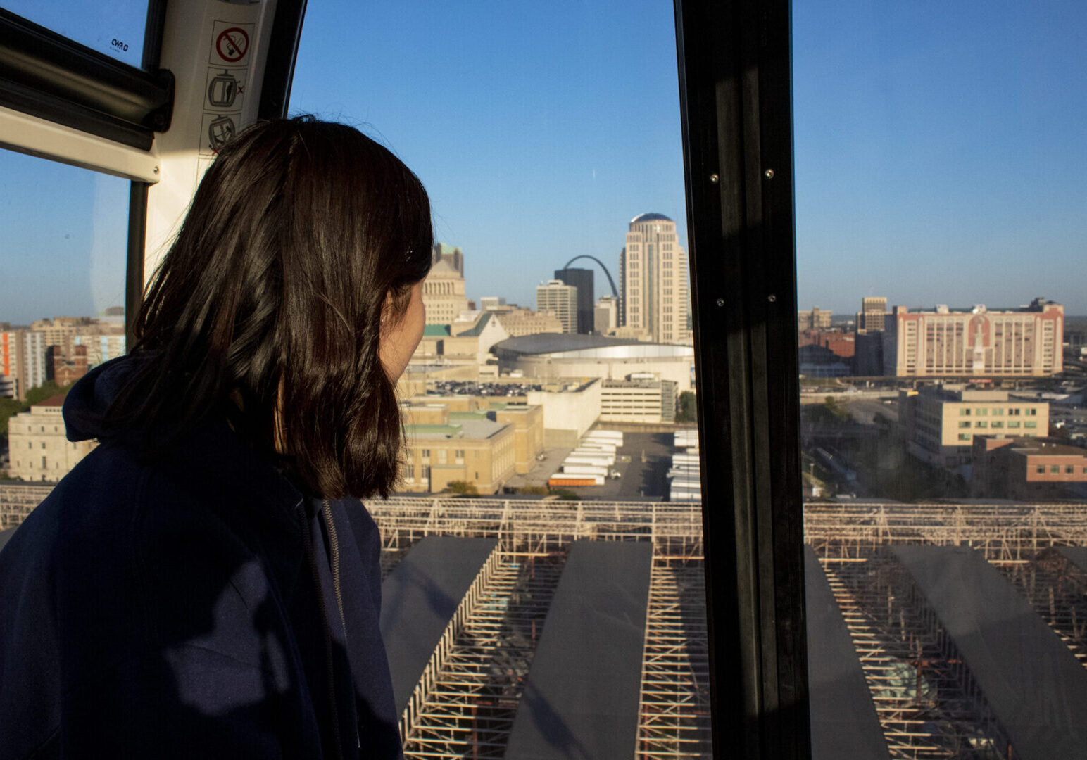 Person in gondola overlooking cityscape