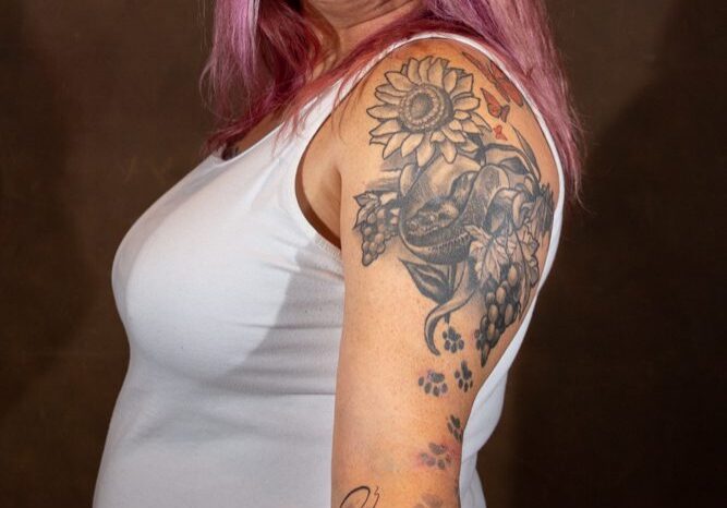 Woman with colorful tattoos and pink hair