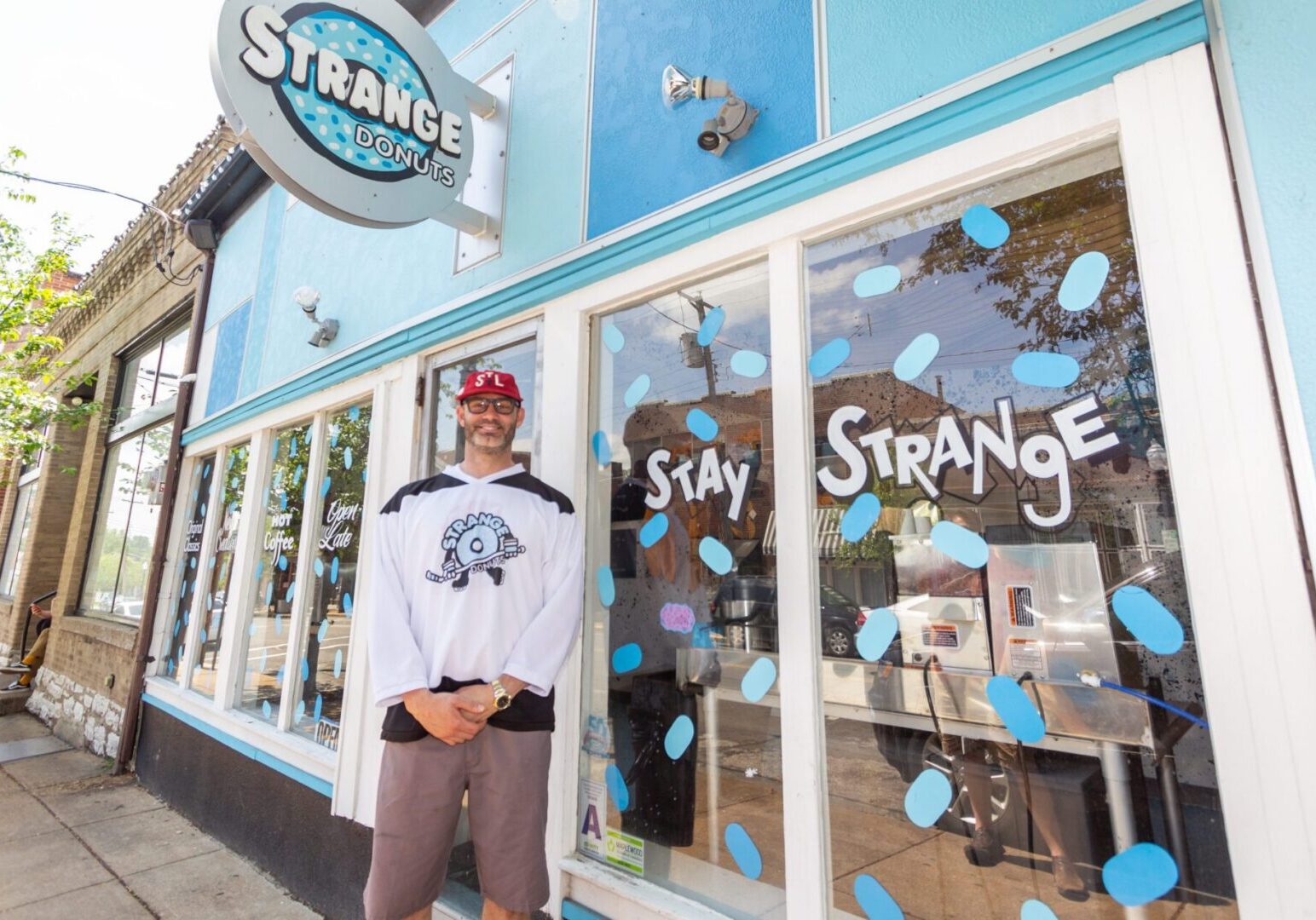 Man stands outside donut shop
