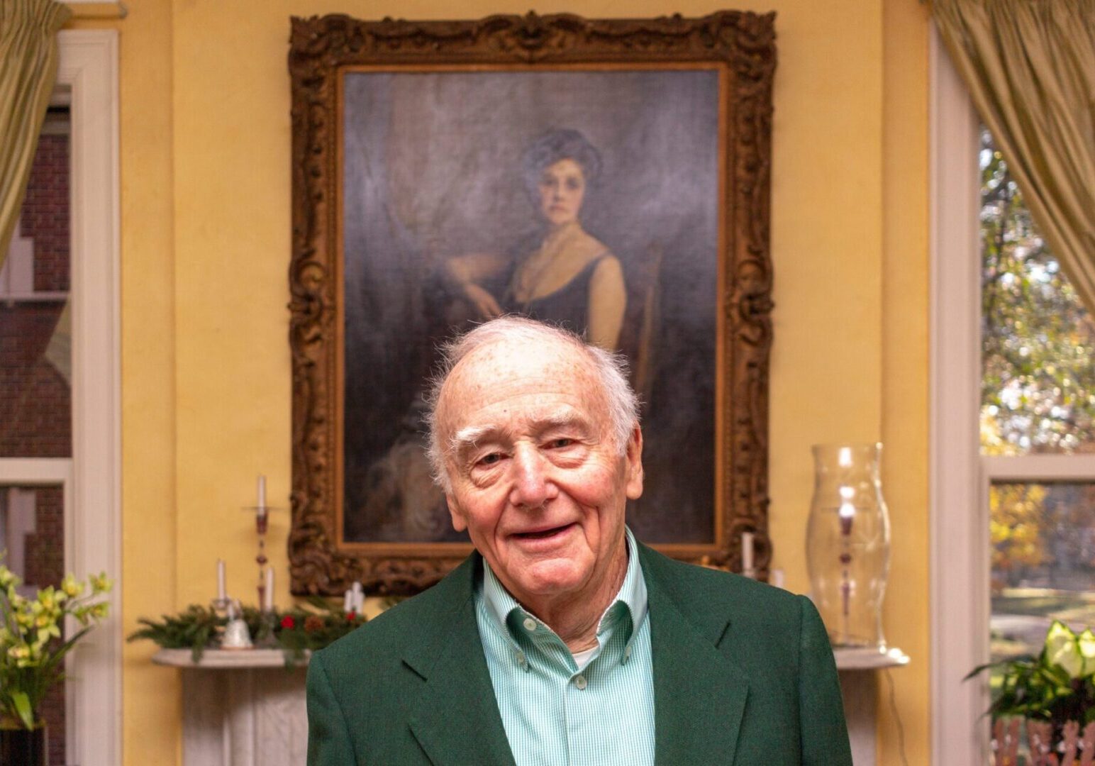 Happy senior standing in elegant room