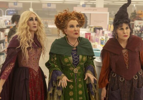 Costumed women standing in a retail aisle