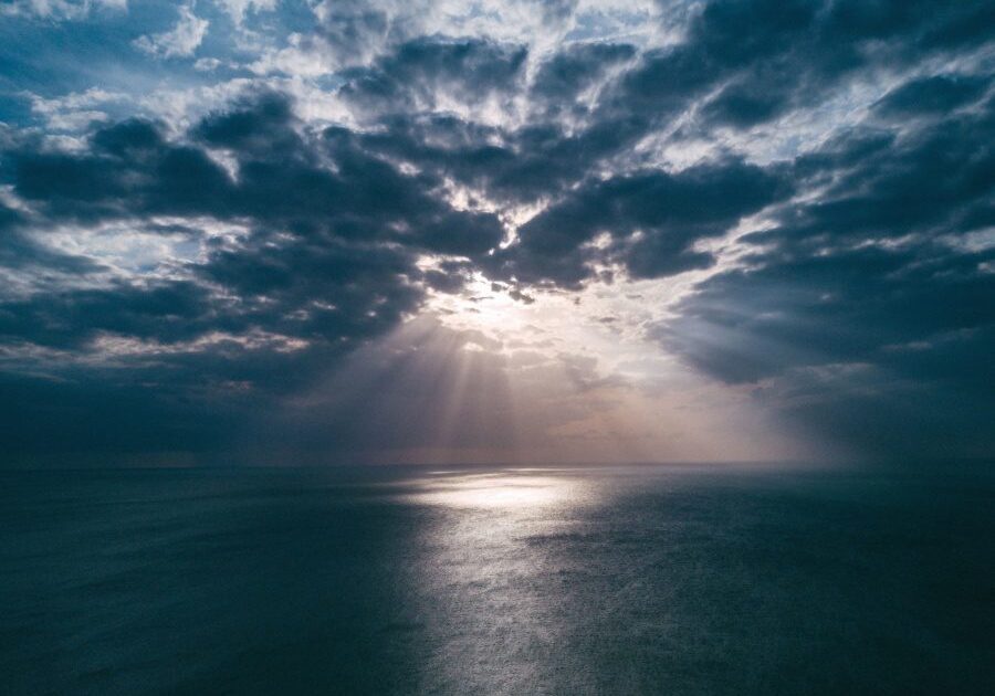 Ocean view with sunrays through clouds