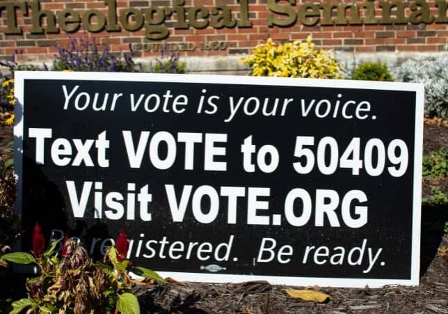 Register to vote sign with website link