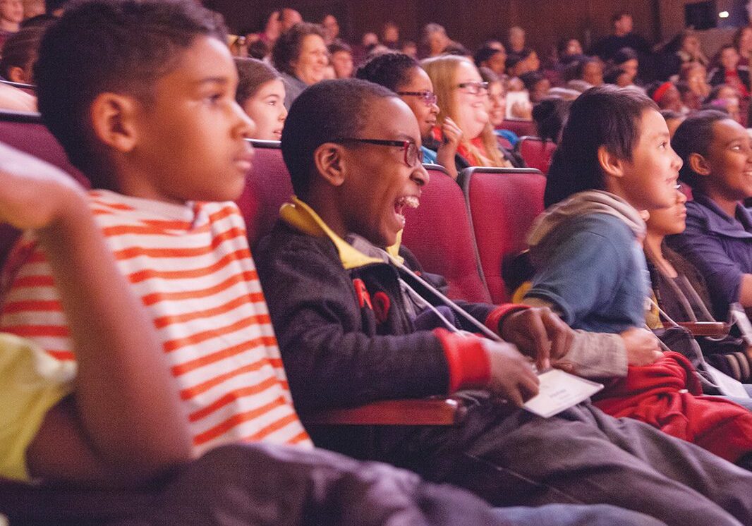 Children laughing in a theater