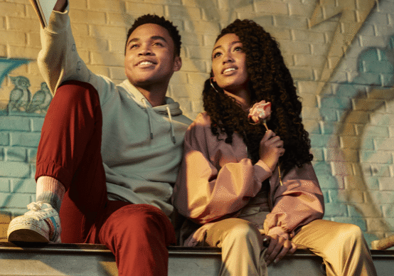 Friends sitting with graffiti background