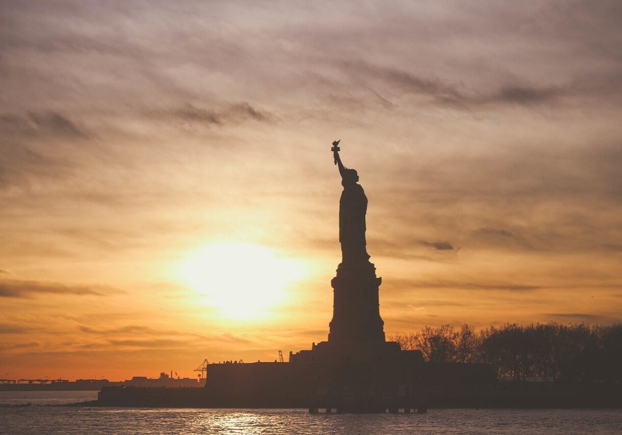 Silhouette of Liberty with sunset backdrop