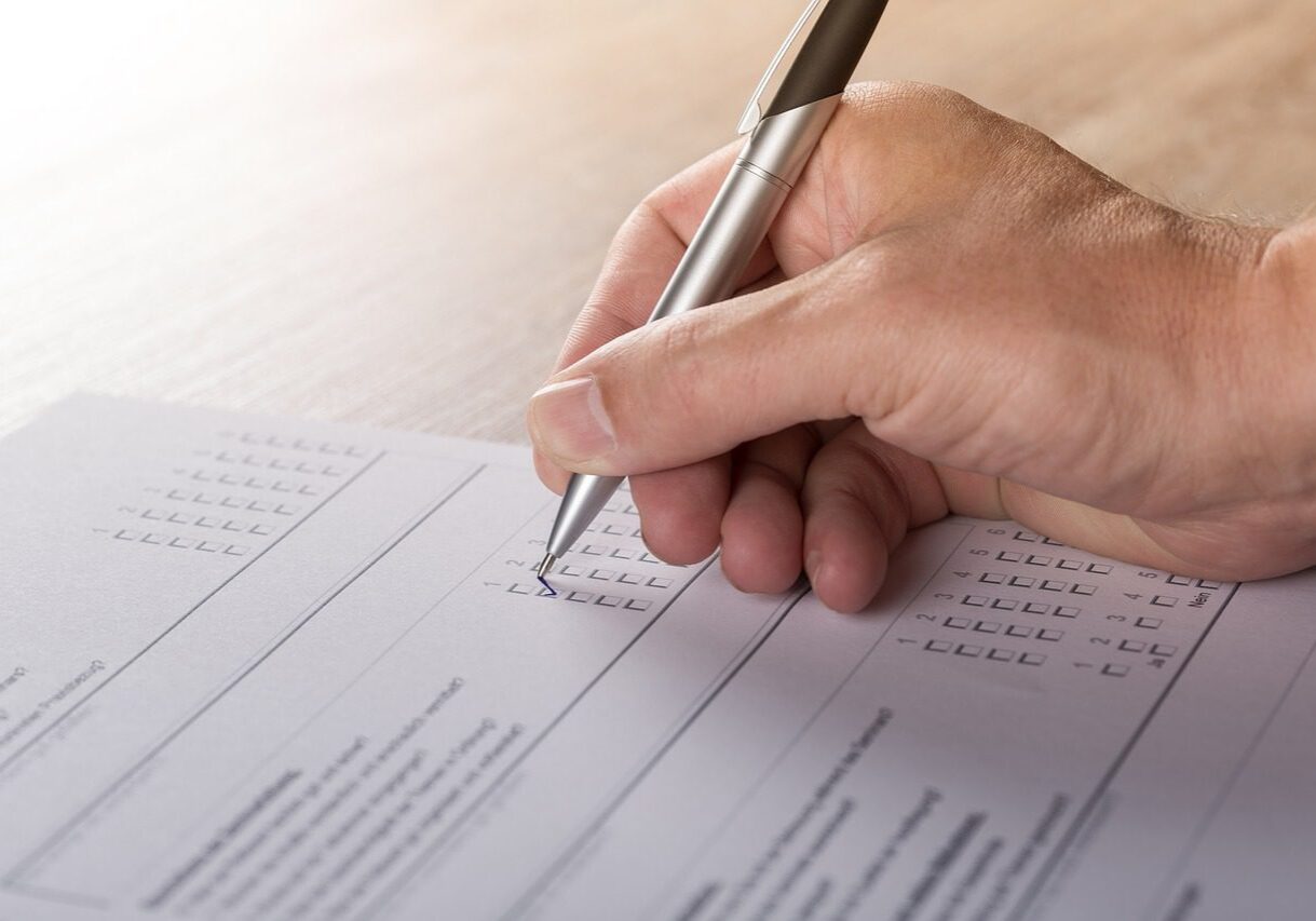 Hand completing a questionnaire