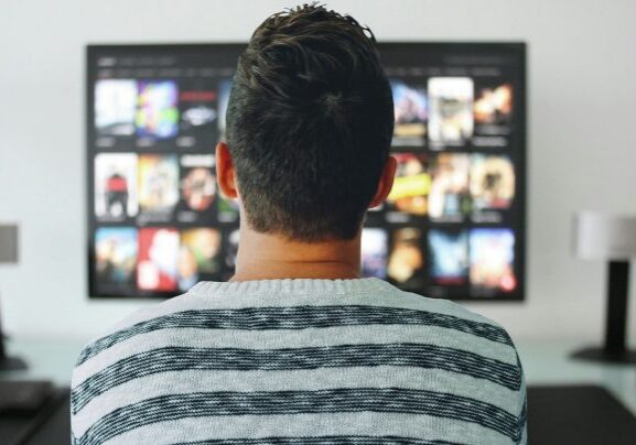 Individual in front of television display