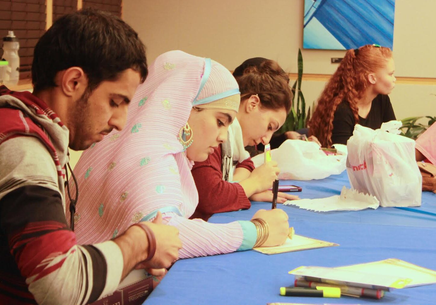 Diverse group engaged in writing activity