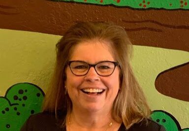 Smiling woman in glasses and black shirt