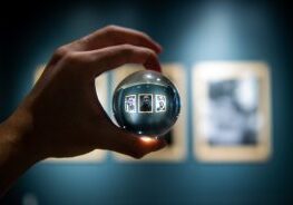 Hand holding crystal ball in gallery