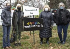 Women standing by Webster Arts sign
