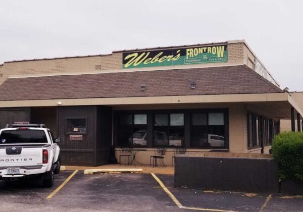 White truck parked outside restaurant