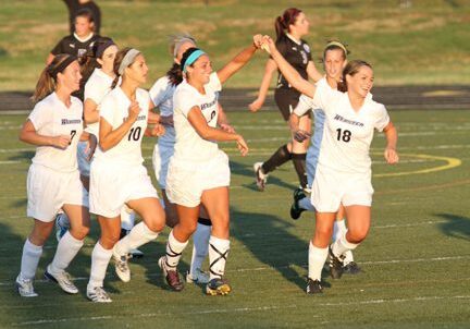 Soccer team celebrating on the field